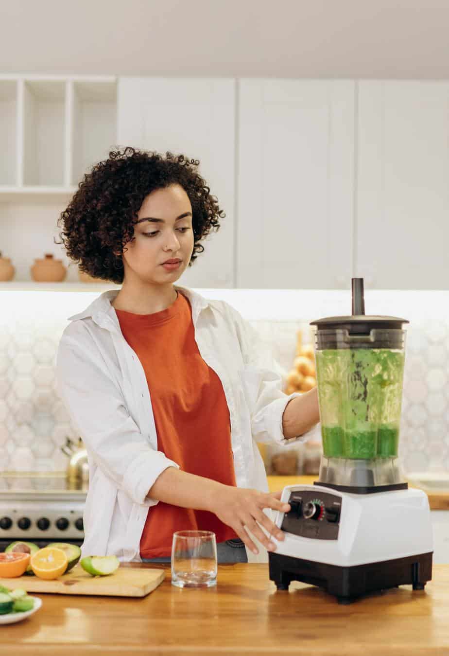 Female with Vitamix blender in kitchen
